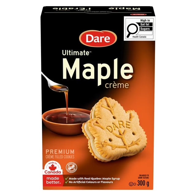 Box of Dare Ultimate Maple Crème cookies with a spoonful of maple syrup and a cookie on an orange background.
