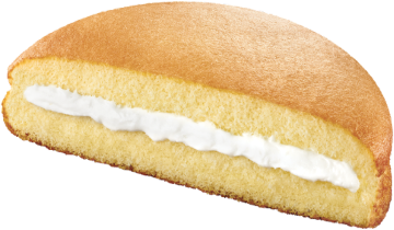 Half-eaten cream-filled bread roll on a white background