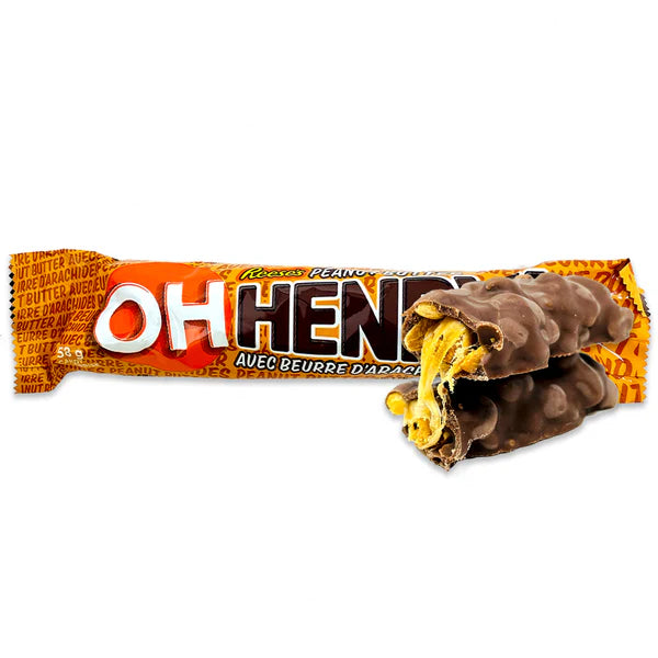 Chocolate bar with a visible bite taken out of it, wrapped in orange and brown packaging.