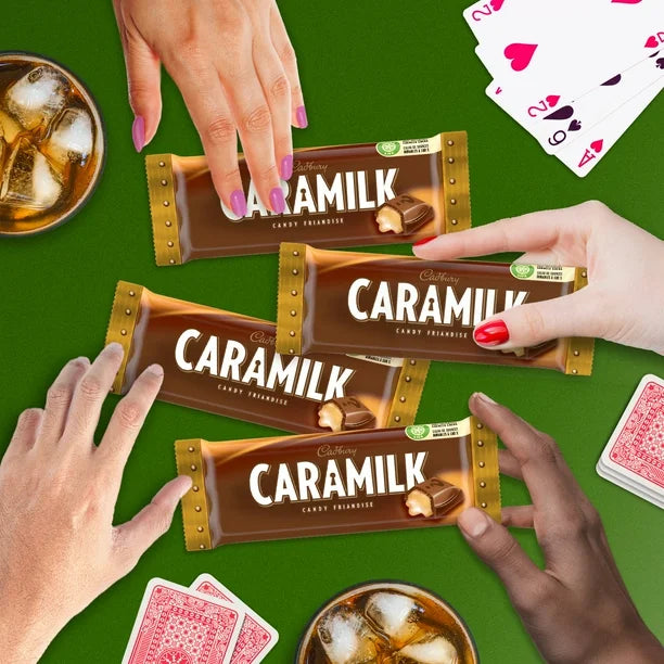 Caramilk chocolate bars with hands and drinks on a green background