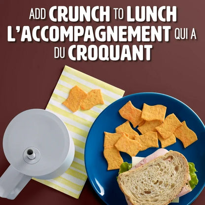 Snack chips on a plate with a sandwich and a container, against a brown background.