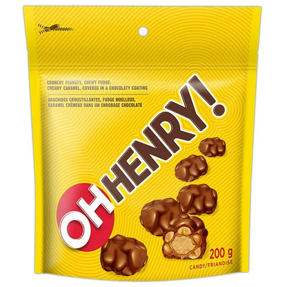 Yellow packaging of Oh Henry! candy with chocolate candies on a white background